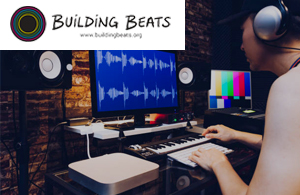 building beats logo in front of a person working at a sound editing station