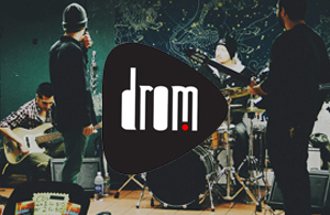 drom logo in front of a band practing